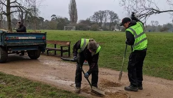 Parks staff filling in potholes